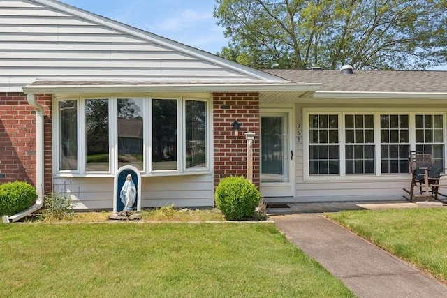 96 Enfield Ct Unit B, Ridge, NY 11961 - property entrance with brick siding and a lawn
