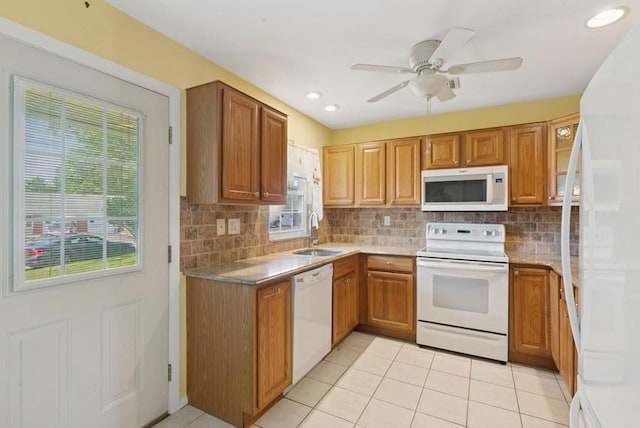 96 Enfield Ct Unit B, Ridge, NY 11961 - kitchen featuring white appliances, healthy amount of natural light, decorative backsplash, and brown cabinetry