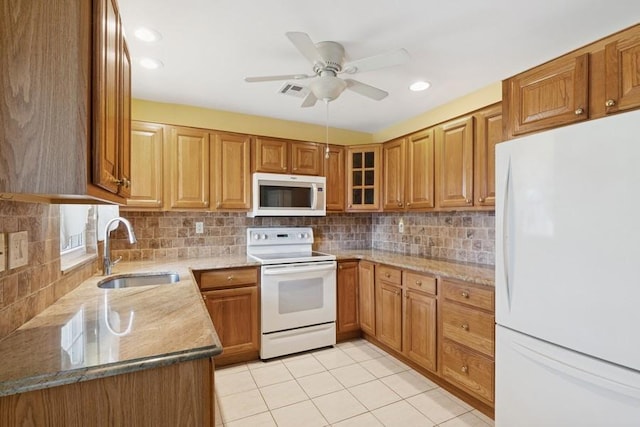 96 Enfield Ct Unit B, Ridge, NY 11961 - kitchen featuring white appliances, light stone counters, brown cabinets, and recessed lighting