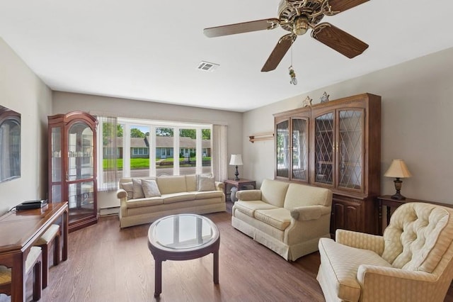 96 Enfield Ct Unit B, Ridge, NY 11961 - living area with a baseboard radiator, wood finished floors, and ceiling fan