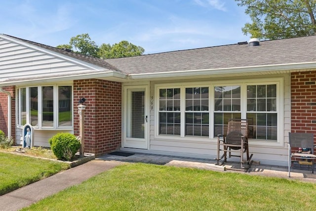 96 Enfield Ct Unit B, Ridge, NY 11961 - entrance to property featuring brick siding, roof with shingles, and a yard
