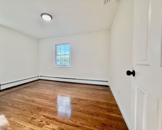 30 7th St, Holbrook, NY 11741 - additional living space featuring wood finished floors and a baseboard heating unit
