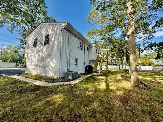 30 7th St, Holbrook, NY 11741 - view of side of property featuring stairway and a lawn
