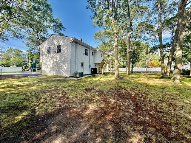30 7th St, Holbrook, NY 11741 - view of home's exterior featuring stairs and a central air condition unit