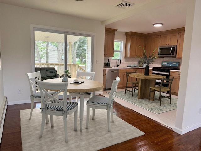 30 7th St, Holbrook, NY 11741 - dining space featuring baseboards and dark wood-type flooring