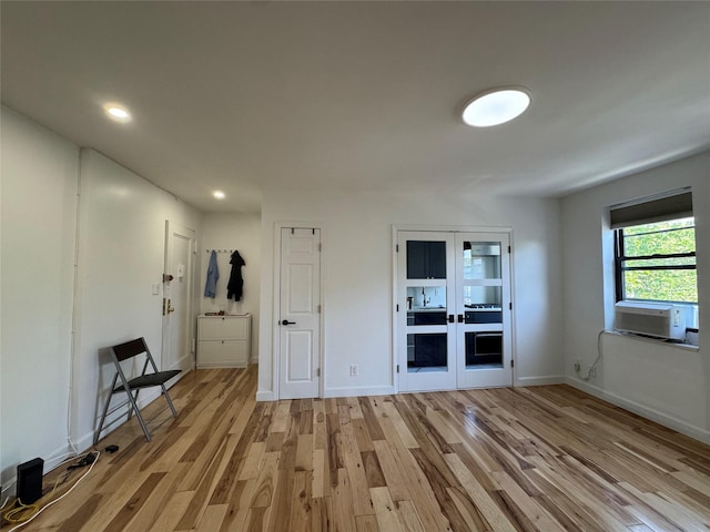 21528 47th Ave Unit 3B, Bayside, NY 11361 - empty room with cooling unit, light wood-type flooring, french doors, and recessed lighting
