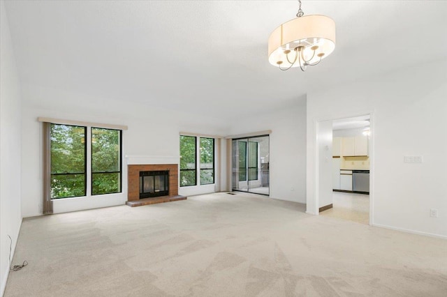 531 Heritage Hls Unit B, Somers, NY 10589 - unfurnished living room with carpet floors, plenty of natural light, a chandelier, and a fireplace
