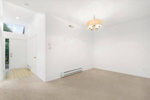 531 Heritage Hls Unit B, Somers, NY 10589 - spare room featuring baseboard heating, carpet floors, a chandelier, a high ceiling, and a smoke detector
