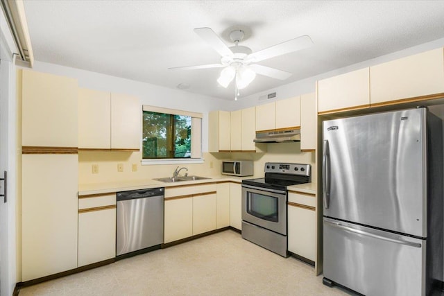 531 Heritage Hls Unit B, Somers, NY 10589 - kitchen with appliances with stainless steel finishes, under cabinet range hood, cream cabinetry, and light countertops