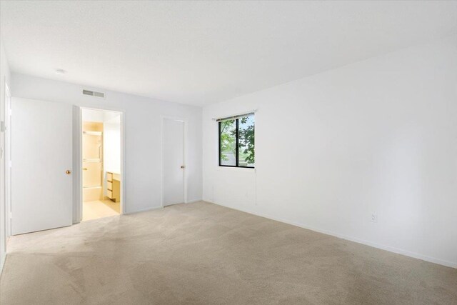 531 Heritage Hls Unit B, Somers, NY 10589 - unfurnished bedroom featuring light carpet and connected bathroom