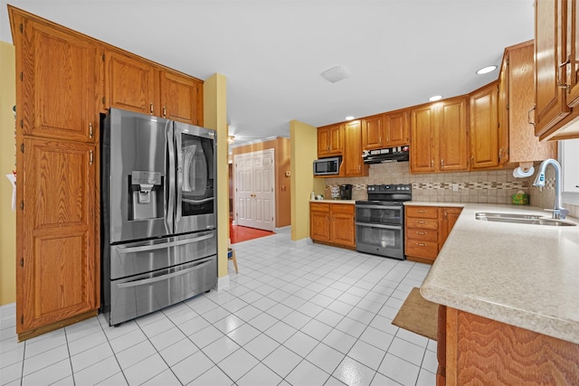 24 Hampton Ct, Wallkill, NY 12589 - kitchen featuring stainless steel appliances, extractor fan, light countertops, decorative backsplash, and brown cabinetry