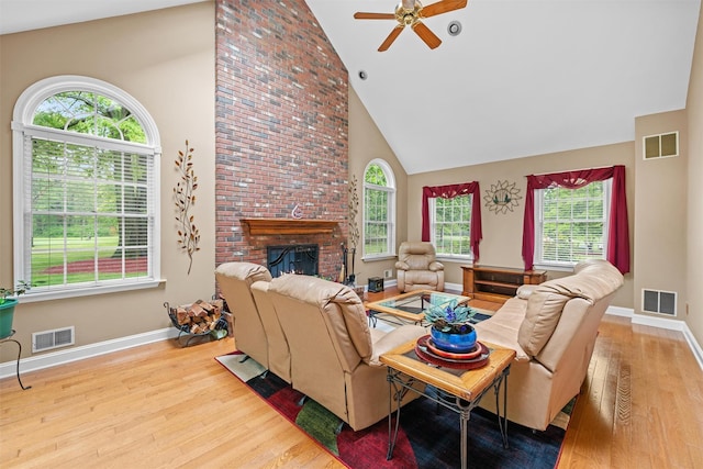 24 Hampton Ct, Wallkill, NY 12589 - living room featuring wood finished floors, high vaulted ceiling, a ceiling fan, and a fireplace