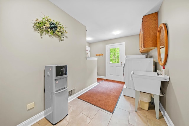 24 Hampton Ct, Wallkill, NY 12589 - laundry room with cabinet space, washing machine and dryer, and light tile patterned floors