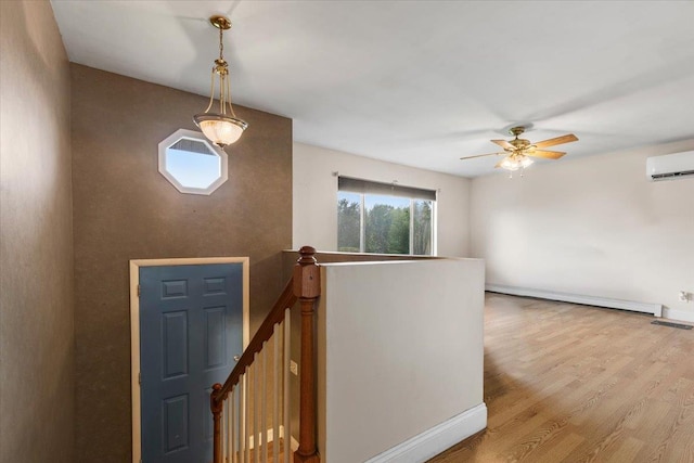 76 Maureen Dr, Middletown, NY 10940 - foyer with baseboard heating, an AC wall unit, wood finished floors, and ceiling fan