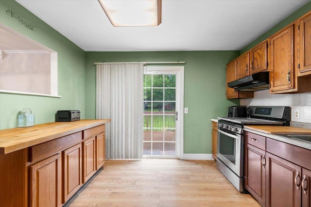 76 Maureen Dr, Middletown, NY 10940 - kitchen with stainless steel gas range oven, under cabinet range hood, light wood-style floors, wooden counters, and brown cabinets