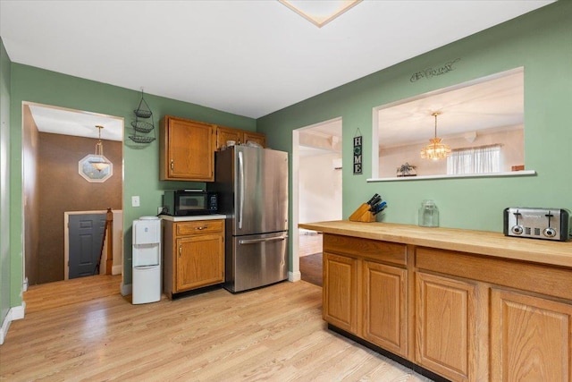 76 Maureen Dr, Middletown, NY 10940 - kitchen featuring freestanding refrigerator, black microwave, light wood finished floors, and brown cabinets