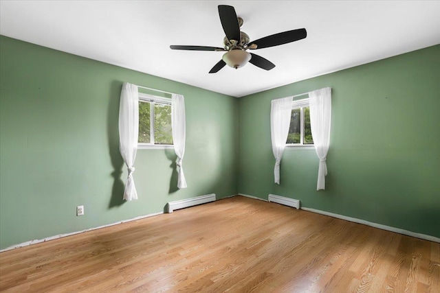 76 Maureen Dr, Middletown, NY 10940 - empty room with baseboard heating, healthy amount of natural light, and wood finished floors