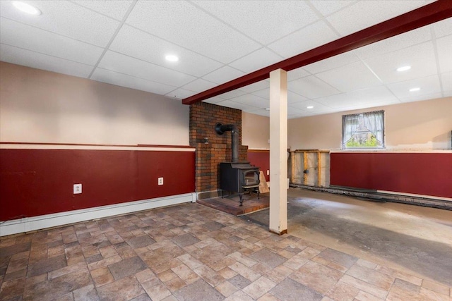 76 Maureen Dr, Middletown, NY 10940 - below grade area with a wood stove, a drop ceiling, stone finish flooring, recessed lighting, and a baseboard radiator