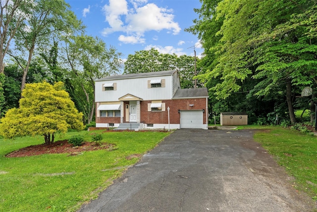 4 Westbrook Dr, Cortlandt Manor, NY 10567 - view of front of home featuring a garage, brick siding, driveway, a front lawn, and view of wooded area