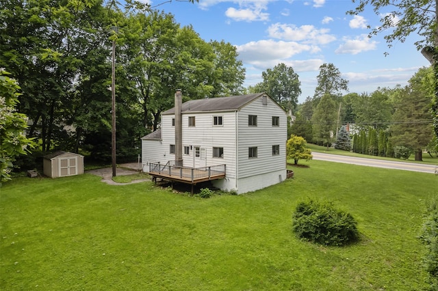 4 Westbrook Dr, Cortlandt Manor, NY 10567 - rear view of house featuring a storage shed, a yard, view of wooded area, and a chimney