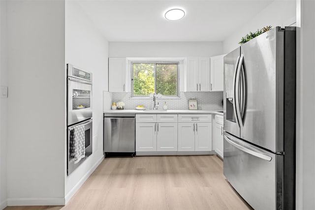 4 Westbrook Dr, Cortlandt Manor, NY 10567 - kitchen featuring stainless steel appliances, light wood-style flooring, light countertops, and white cabinets