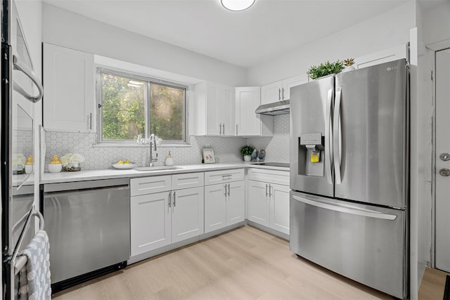 4 Westbrook Dr, Cortlandt Manor, NY 10567 - kitchen featuring appliances with stainless steel finishes, white cabinets, light countertops, and light wood finished floors