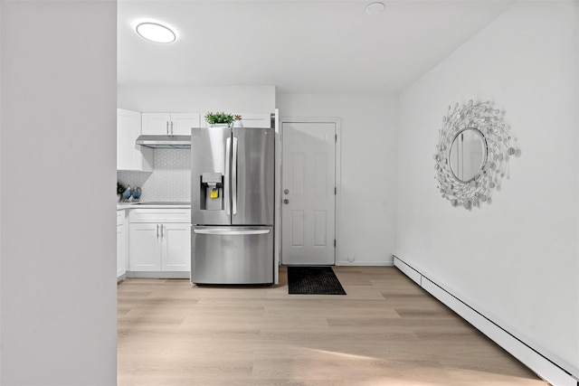 4 Westbrook Dr, Cortlandt Manor, NY 10567 - kitchen featuring stainless steel fridge, a baseboard heating unit, under cabinet range hood, white cabinetry, and light wood finished floors