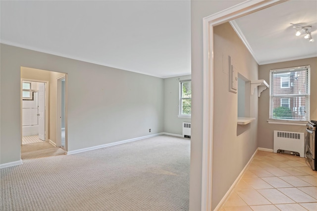 13 Bryant Cres Unit 1F, White Plains, NY 10605 - hallway with radiator heating unit, ornamental molding, light colored carpet, and light tile patterned floors