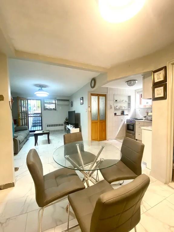 22-39 74th St, East Elmhurst, NY 11370 - dining space with radiator and light marble finish floors