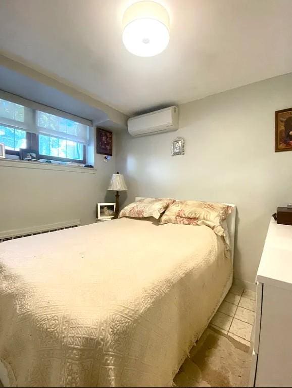22-39 74th St, East Elmhurst, NY 11370 - bedroom with a wall mounted AC and light tile patterned flooring