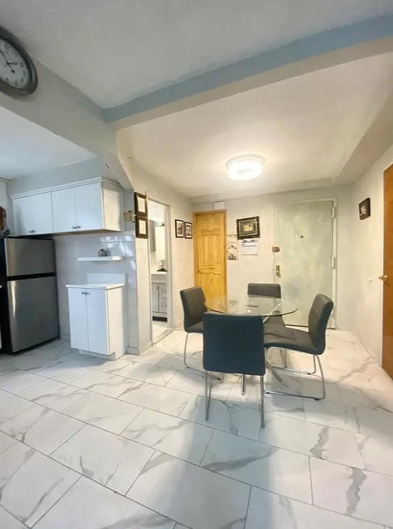 22-39 74th St, East Elmhurst, NY 11370 - dining room featuring light marble finish flooring