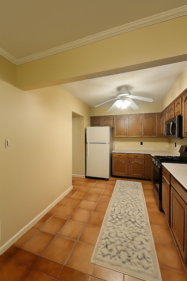 22-39 74th St, East Elmhurst, NY 11370 - kitchen with freestanding refrigerator, range with gas cooktop, stainless steel microwave, light countertops, and light tile patterned floors
