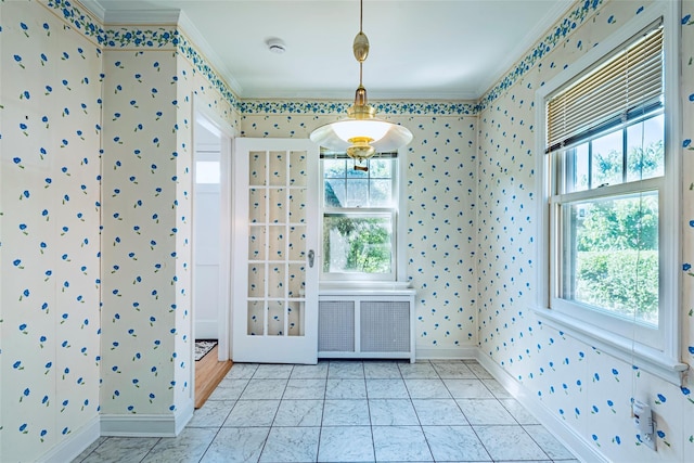 147 Nugent St, New Hyde Park, NY 11040 - unfurnished dining area with wallpapered walls, ornamental molding, plenty of natural light, and radiator