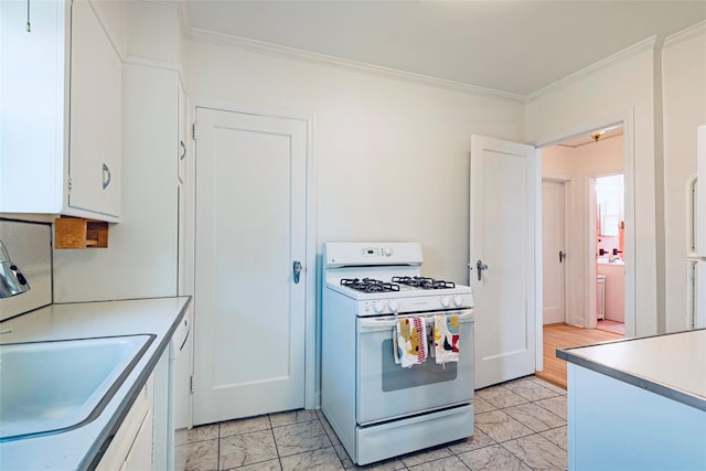 147 Nugent St, New Hyde Park, NY 11040 - kitchen with white appliances, ornamental molding, white cabinetry, and light countertops
