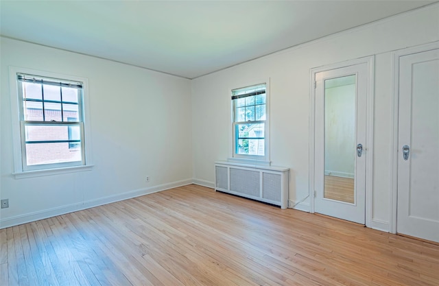 147 Nugent St, New Hyde Park, NY 11040 - unfurnished room with radiator and light wood-style floors