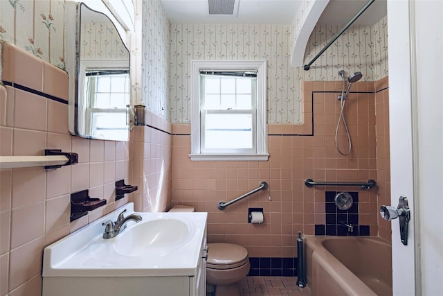 147 Nugent St, New Hyde Park, NY 11040 - full bathroom featuring wallpapered walls, tile walls, healthy amount of natural light, vanity, and tub / shower combination
