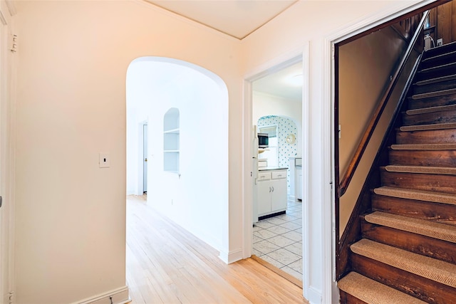 147 Nugent St, New Hyde Park, NY 11040 - stairs with arched walkways, wood finished floors, and crown molding