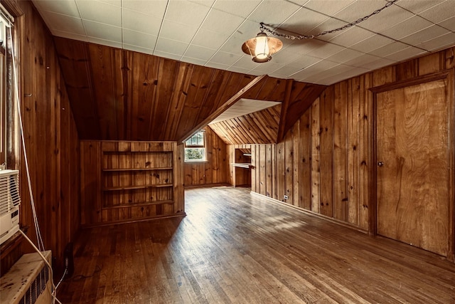 147 Nugent St, New Hyde Park, NY 11040 - additional living space featuring wood walls, hardwood / wood-style floors, vaulted ceiling, and built in features