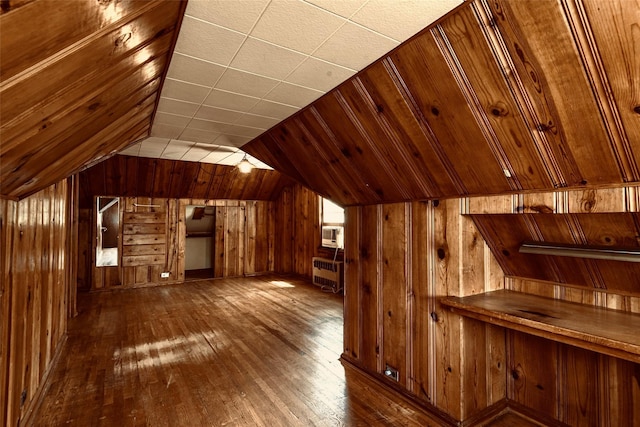 147 Nugent St, New Hyde Park, NY 11040 - bonus room featuring wood walls, radiator, lofted ceiling, and hardwood / wood-style floors
