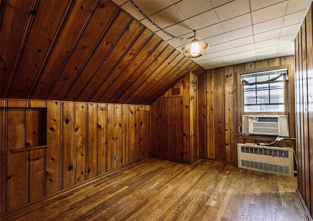 147 Nugent St, New Hyde Park, NY 11040 - additional living space featuring radiator, vaulted ceiling, wood-type flooring, wood walls, and cooling unit