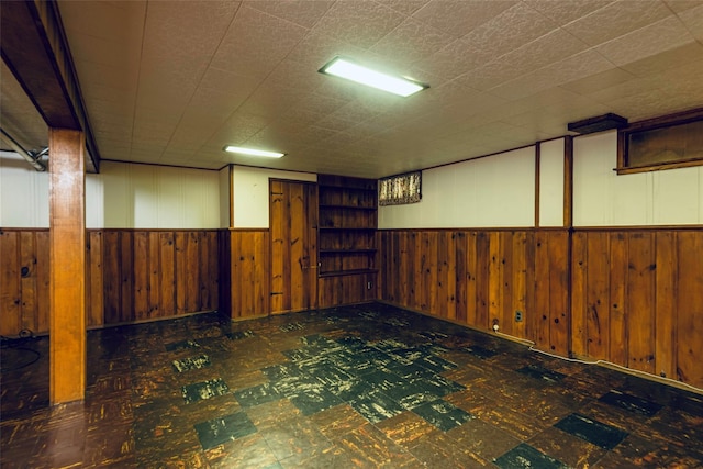 147 Nugent St, New Hyde Park, NY 11040 - finished below grade area with tile patterned floors, wooden walls, and a wainscoted wall