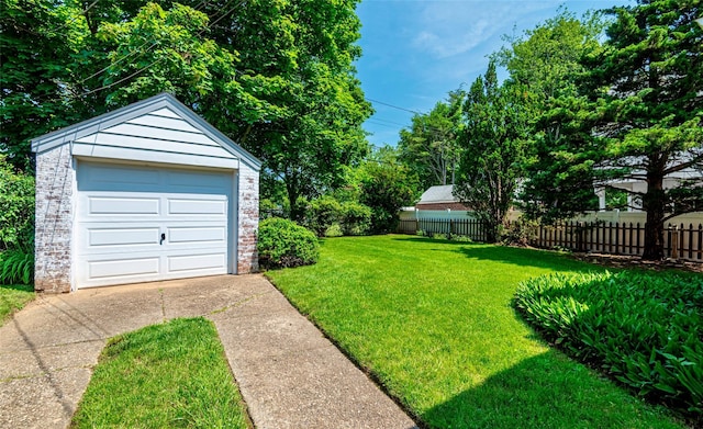 147 Nugent St, New Hyde Park, NY 11040 - view of yard featuring driveway, a garage, and an outbuilding