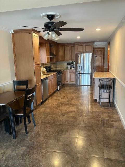 16330 95th St, Howard Beach, NY 11414 - kitchen featuring stainless steel appliances, a ceiling fan, ornamental molding, light countertops, and recessed lighting