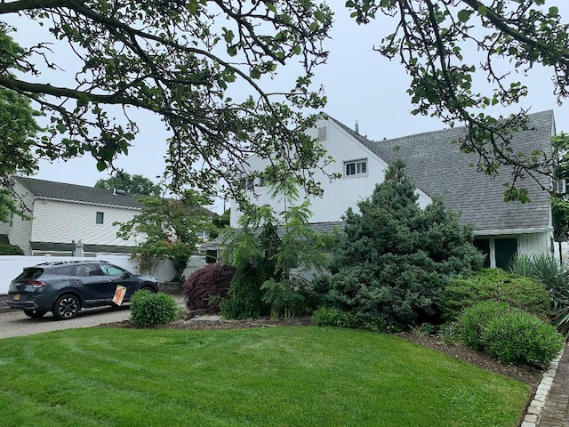 231 Willowood Dr, Wantagh, NY 11793 - view of side of home with a lawn and a shingled roof
