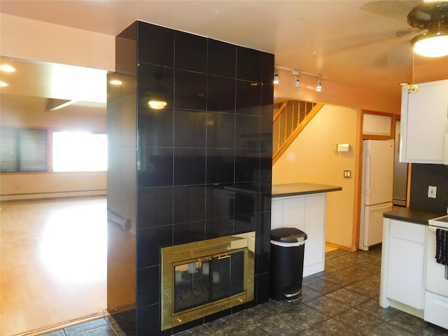 231 Willowood Dr, Wantagh, NY 11793 - kitchen featuring dark countertops, freestanding refrigerator, white cabinetry, ceiling fan, and rail lighting