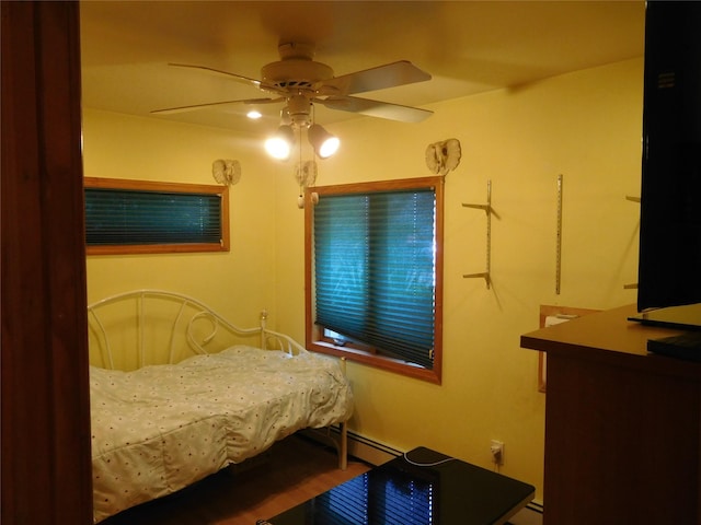 231 Willowood Dr, Wantagh, NY 11793 - bedroom with a baseboard radiator, ceiling fan, and wood finished floors