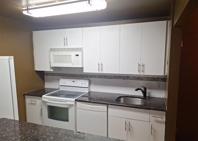 715 Fox St Unit 5J, Bronx, NY 10455 - kitchen with white appliances, decorative backsplash, white cabinetry, and dark stone counters