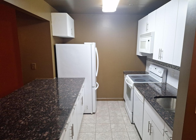 715 Fox St Unit 5J, Bronx, NY 10455 - kitchen featuring white appliances, white cabinetry, and dark stone counters
