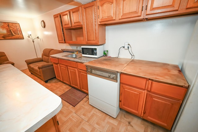 5920 69th Pl, Maspeth, NY 11378 - kitchen featuring white appliances, light floors, light countertops, and brown cabinetry