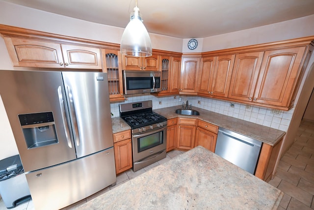 5920 69th Pl, Maspeth, NY 11378 - kitchen featuring appliances with stainless steel finishes, backsplash, light stone countertops, and glass insert cabinets